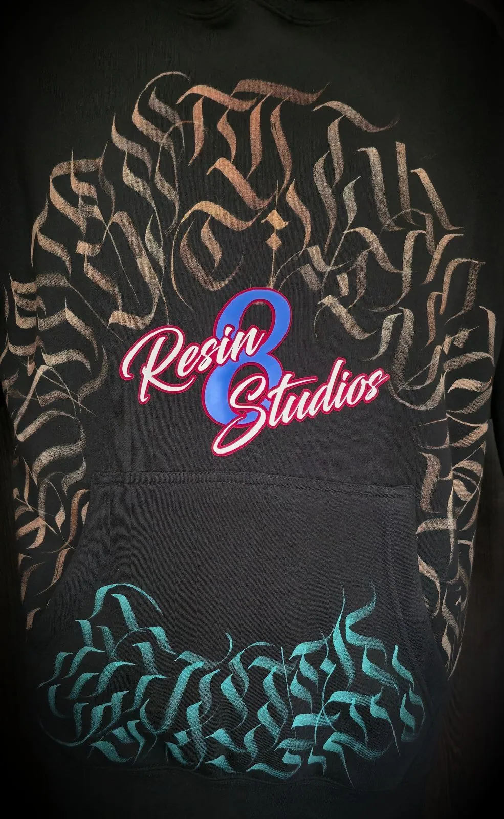 Resin 8 Studios hoodie — hand-finished calligraphy back print from the apparel workshop