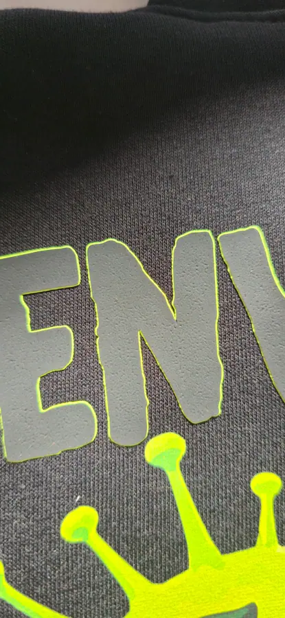 Close-up of print and embroidery detail on a garment by Resin 8 Studios
