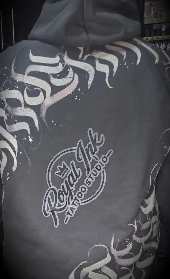Hand-painted calligraphy back print on a custom hoodie by Resin 8 Studios