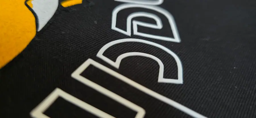 Close-up of print and embroidery detail on a garment by Resin 8 Studios